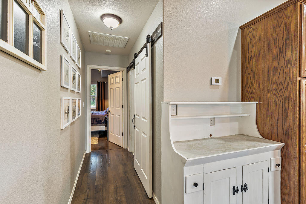 167 Rippling Way Merlin, OR 97532 - Photo 20 of 39 a view of a hallway with wooden cabinets and entryway