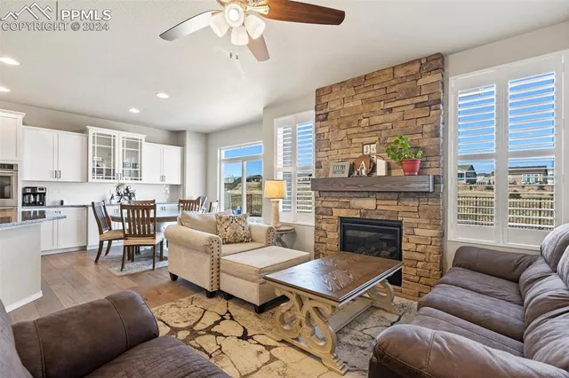 a living room with furniture wooden floor and a fireplace