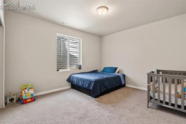 a spacious bedroom with a bed and a window