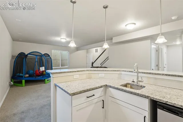 a kitchen with a sink a stove and cabinets