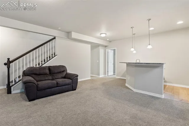 a living room with furniture and a ceiling fan