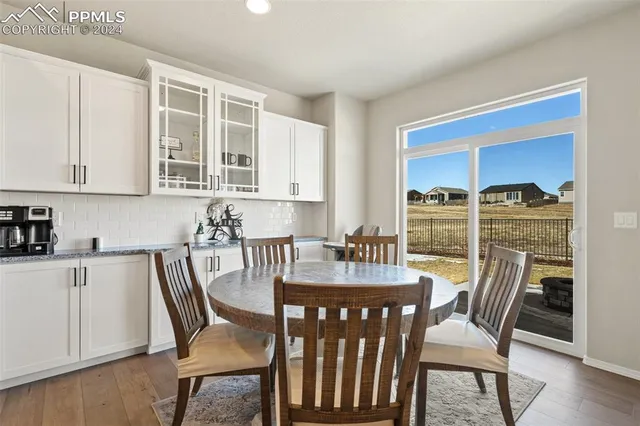 a view of a dining room with furniture window and wooden floor
