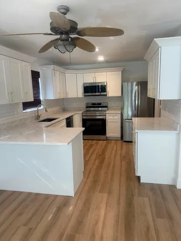 a kitchen with a stove a refrigerator and a sink