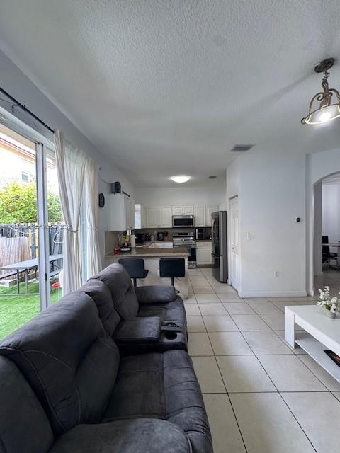 12923 Southwest 135th Terrace Miami, FL 33186 - Photo 12 of 71 a living room with furniture and a large window