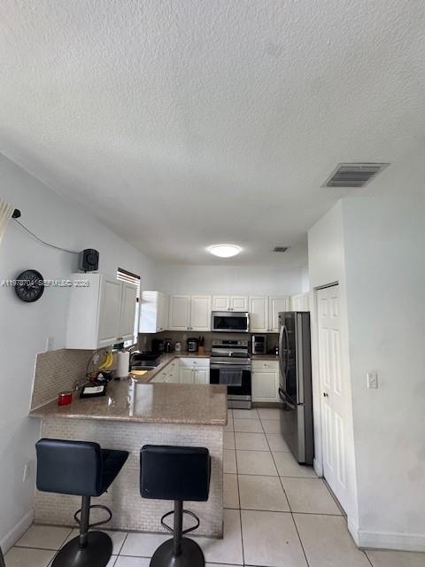 12923 Southwest 135th Terrace Miami, FL 33186 - Photo 13 of 71 a kitchen with stainless steel appliances kitchen island granite countertop a refrigerator and a stove top oven