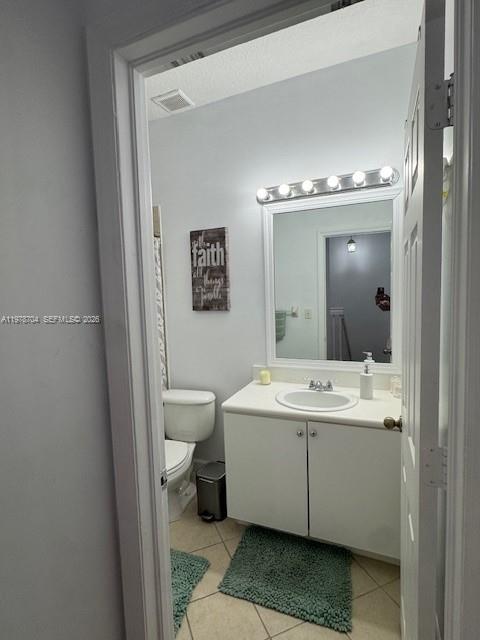 12923 Southwest 135th Terrace Miami, FL 33186 - Photo 35 of 71 a bathroom with a toilet sink and mirror