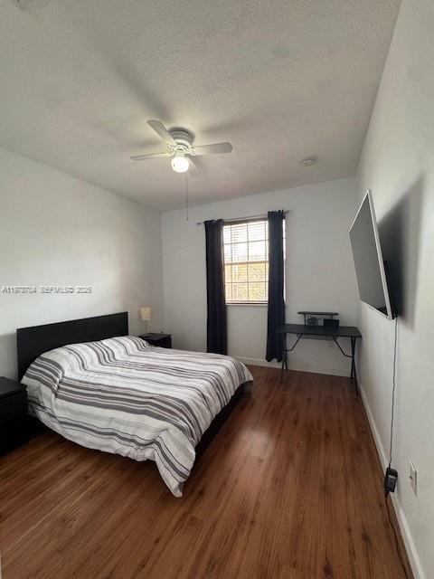 12923 Southwest 135th Terrace Miami, FL 33186 - Photo 38 of 71 a bedroom with a bed and a flat tv screen on a dresser