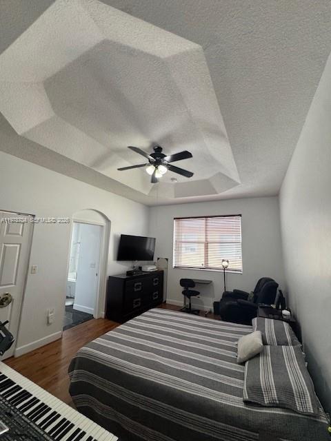 12923 Southwest 135th Terrace Miami, FL 33186 - Photo 47 of 71 a bedroom with a large bed and a flat tv screen