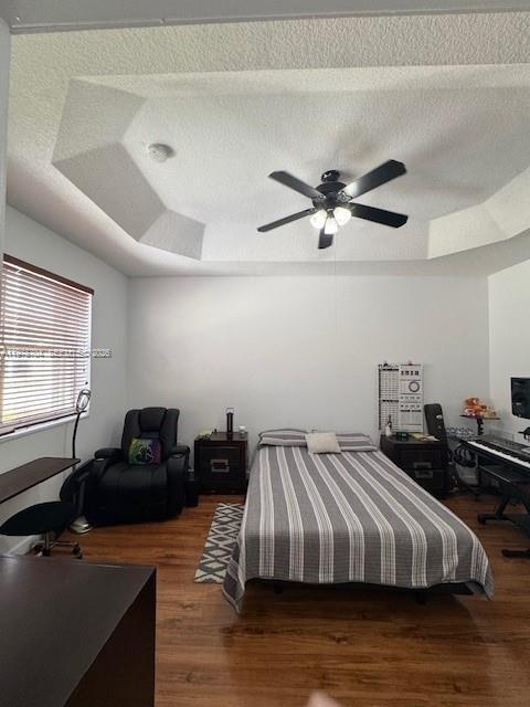 12923 Southwest 135th Terrace Miami, FL 33186 - Photo 49 of 71 a bedroom with a bed and wooden floor