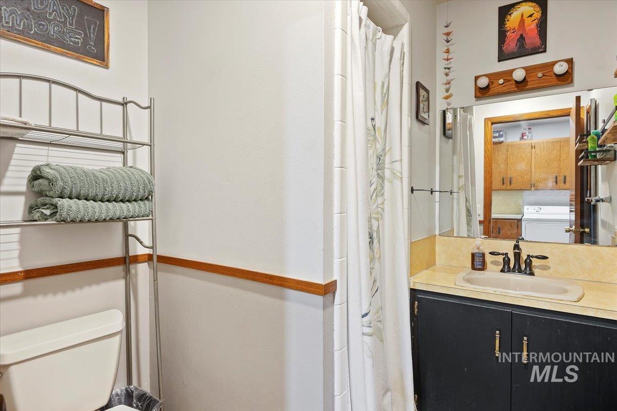 173 Main Line Ranch Road Rupert, ID 83350 - Photo 21 of 47 Bathroom with a shower with shower curtain, vanity, and washer / dryer