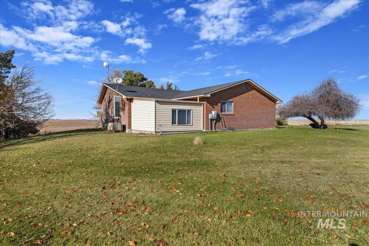 173 Main Line Ranch Road Rupert, ID 83350 - Photo 35 of 47 View of side of home featuring a yard and brick siding