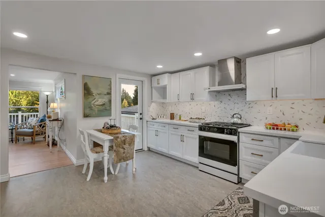 a kitchen with stainless steel appliances granite countertop a stove sink and cabinets