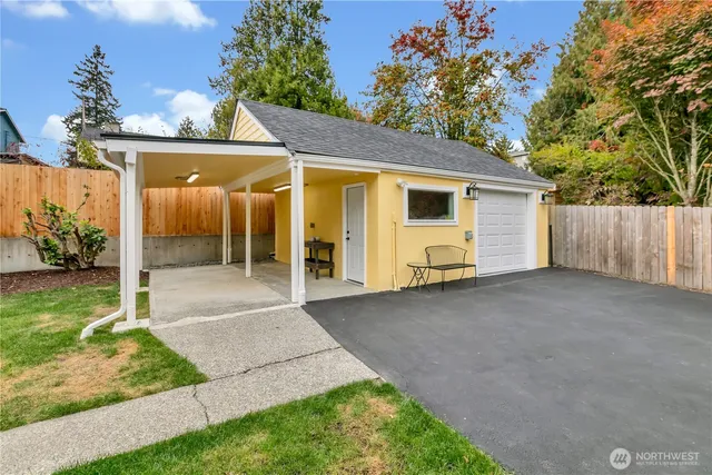 a view of a house with backyard and garage
