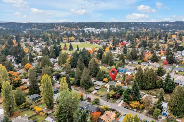 an aerial view of a house with a yard