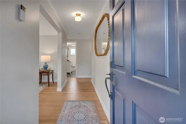 a hall way with furniture and a mirror