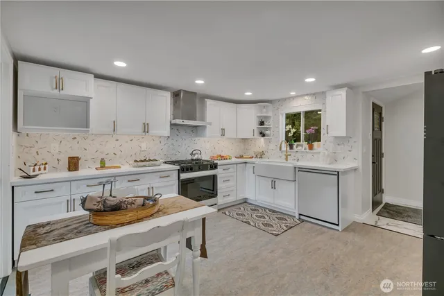 a kitchen with a sink stove top oven and microwave
