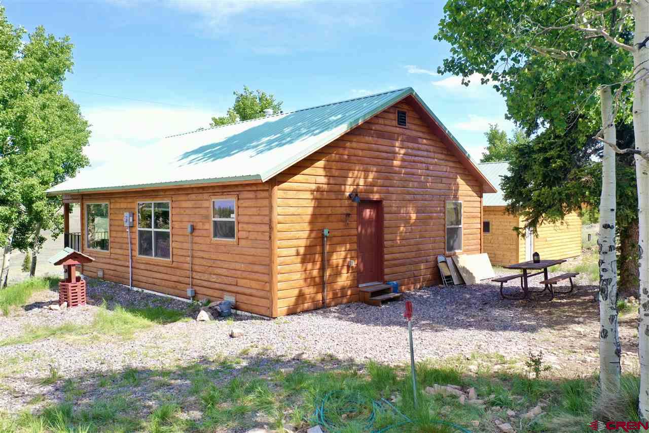 1019 Uncompahgre Drive Powderhorn, CO 81243 - Photo 14 of 33 a view of a house with a yard