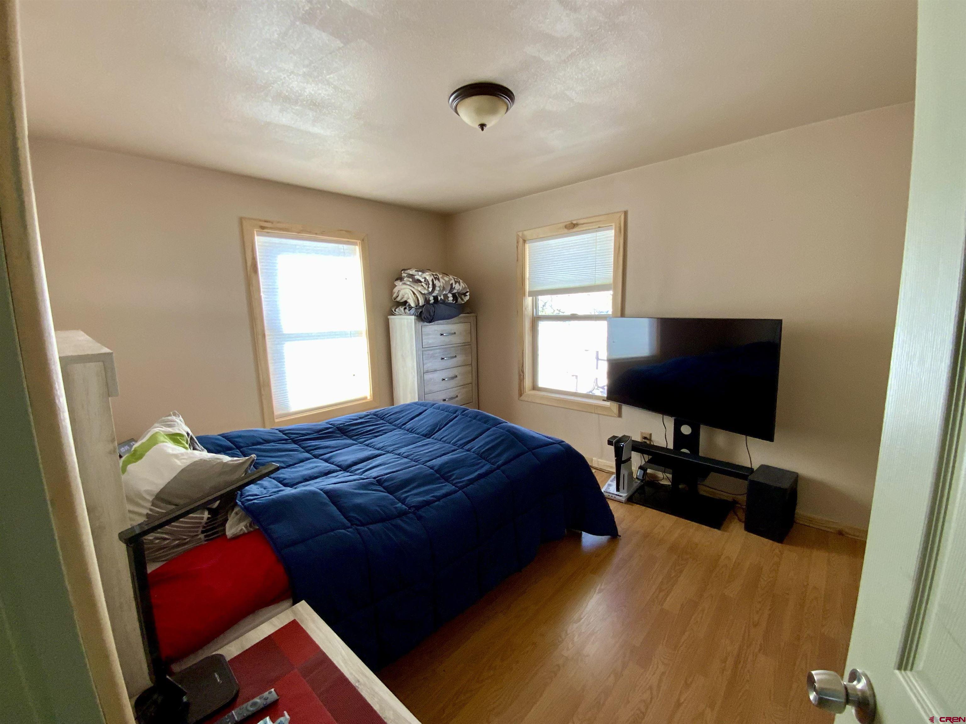 1019 Uncompahgre Drive Powderhorn, CO 81243 - Photo 19 of 33 a bedroom with a bed and flat screen tv
