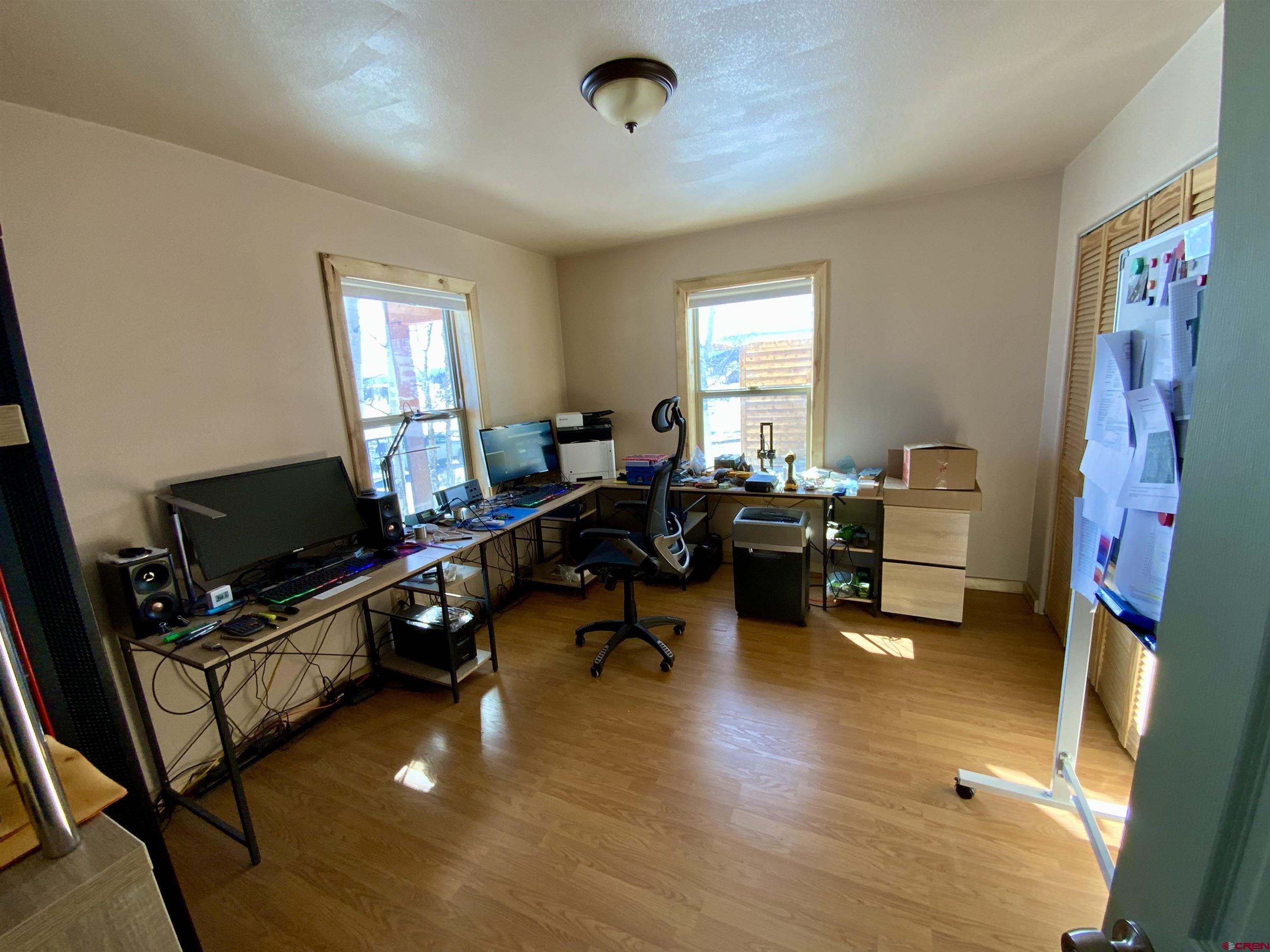 1019 Uncompahgre Drive Powderhorn, CO 81243 - Photo 22 of 33 a living room with furniture and a flat screen tv