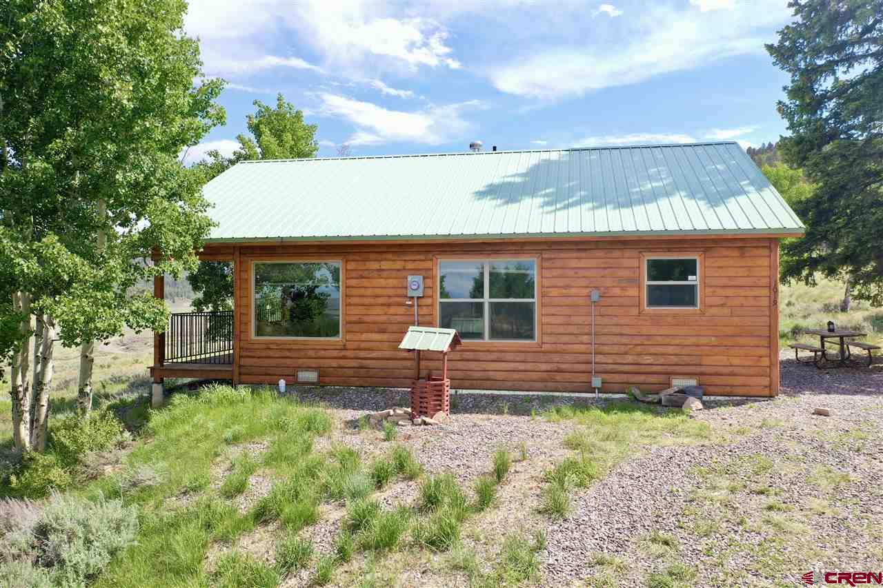 1019 Uncompahgre Drive Powderhorn, CO 81243 - Photo 10 of 33 a front view of a house with garden