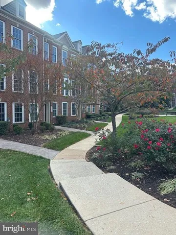 a view of a garden with a house