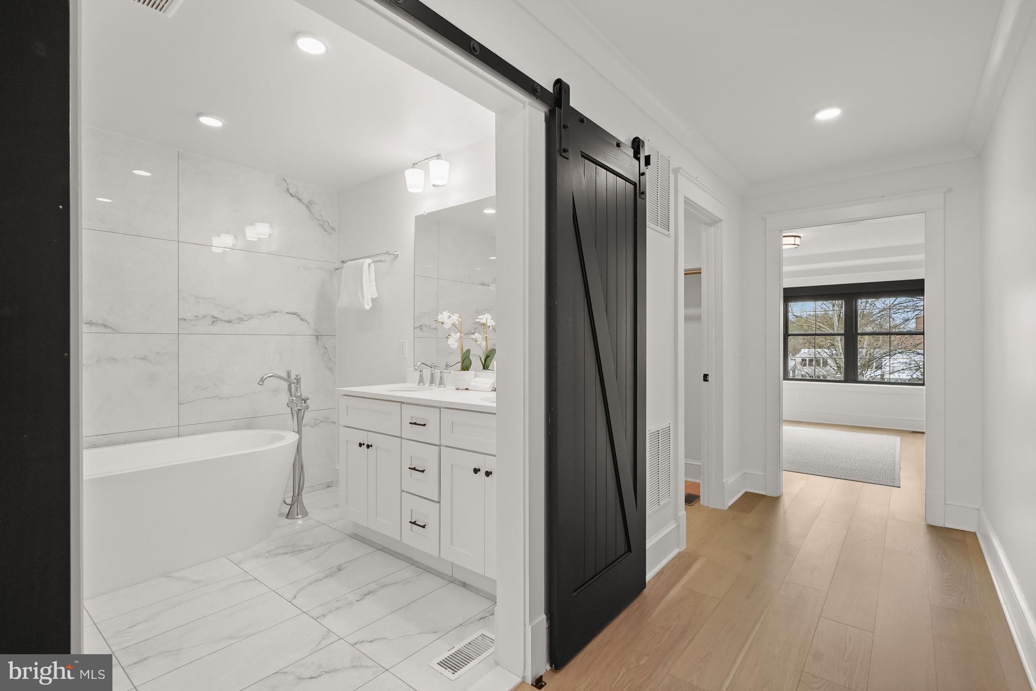 3719 R Street Northwest Washington, DC 20007 - Photo 16 of 44 a bathroom with a bathtub a double vanity sink and mirrors