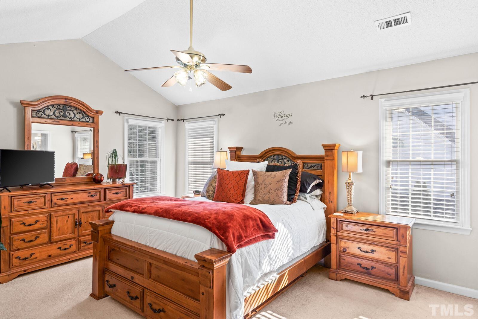 12104 Amoretto Way Raleigh, NC 27613 - Photo 12 of 21 a bedroom with a bed and a flat screen tv