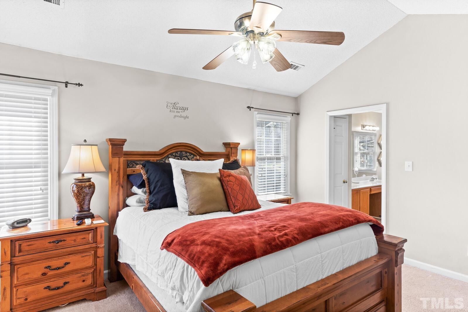 12104 Amoretto Way Raleigh, NC 27613 - Photo 13 of 21 a bed room with a bed and a chandelier