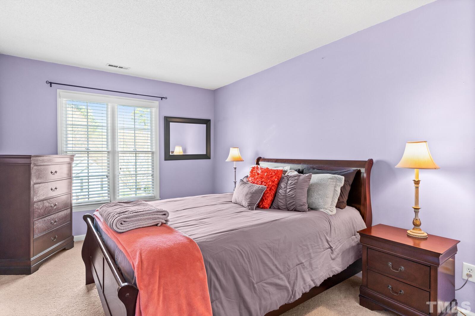12104 Amoretto Way Raleigh, NC 27613 - Photo 16 of 21 a bedroom with a bed and a lamp