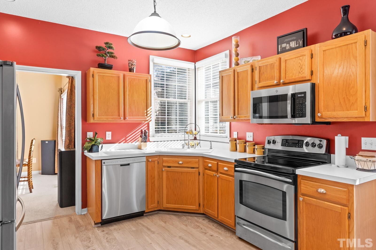 12104 Amoretto Way Raleigh, NC 27613 - Photo 7 of 21 a kitchen that has a sink and a stove in it