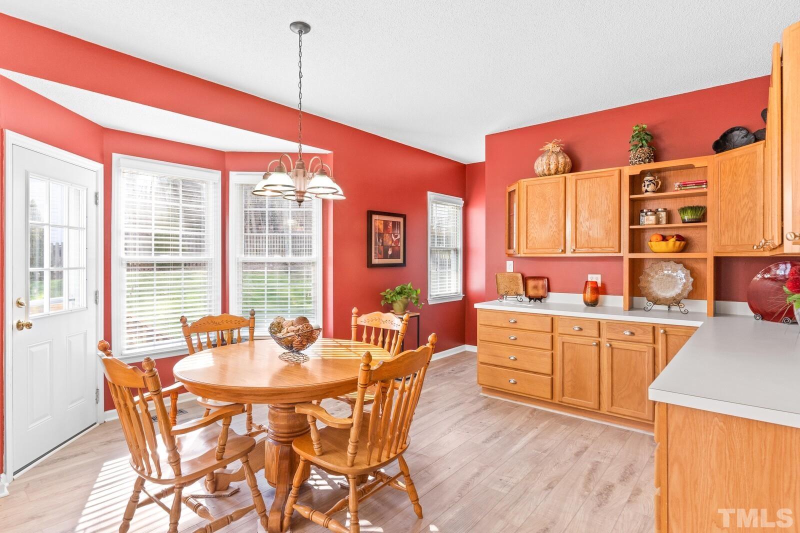 12104 Amoretto Way Raleigh, NC 27613 - Photo 9 of 21 a large kitchen with a table and chairs in it