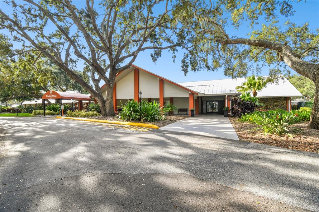 11340 Carriage Hill Drive, Unit 4 Port Richey, FL 34668 - Photo 23 of 36 a front view of a house with a yard and a garage
