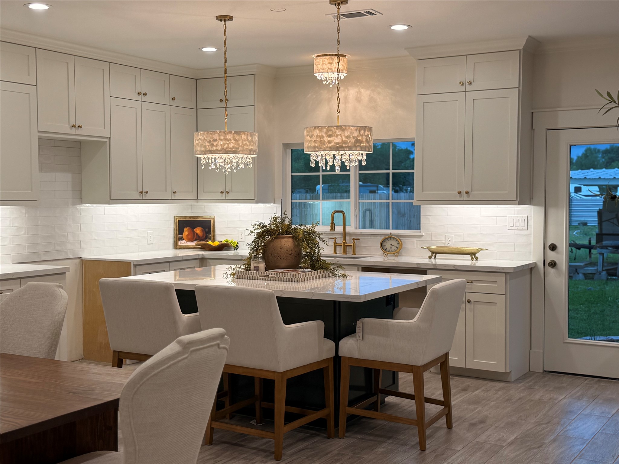 407 Harris Road Highlands, TX 77562 - Photo 1 of 32 a kitchen with a sink and chairs