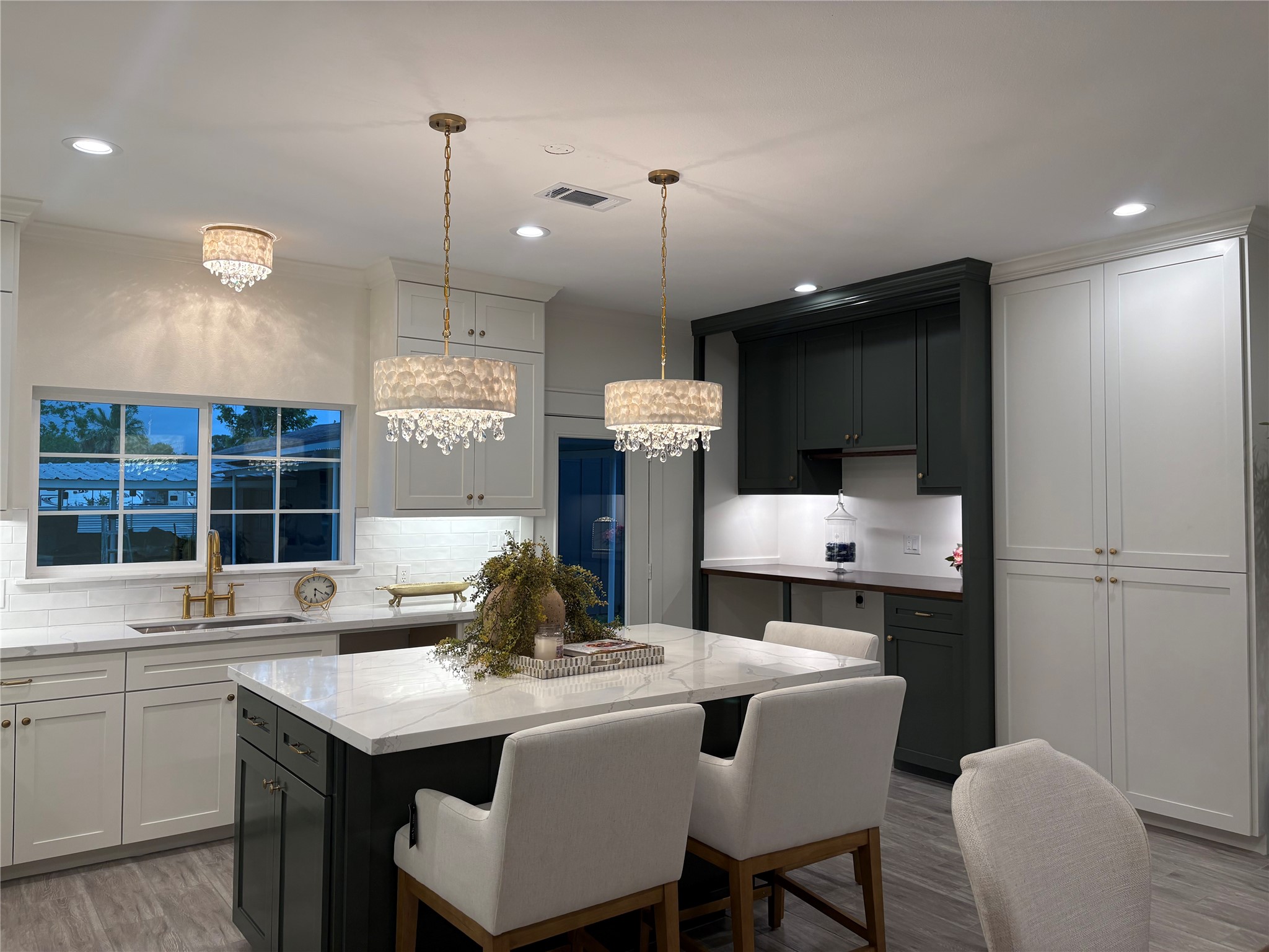 407 Harris Road Highlands, TX 77562 - Photo 14 of 32 a kitchen with a dining table chairs sink and cabinets