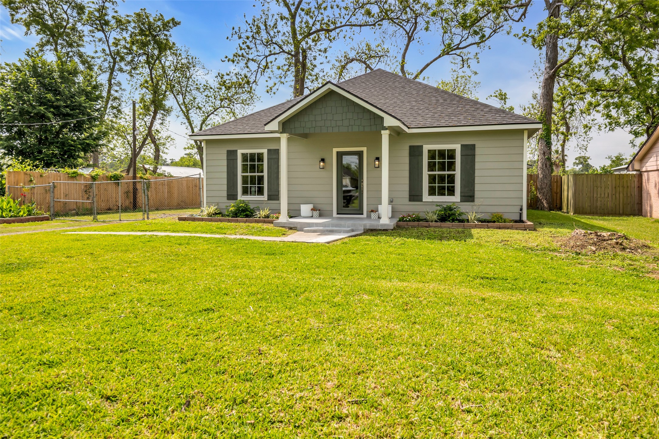 407 Harris Road Highlands, TX 77562 - Photo 2 of 32 a front view of a house with a yard and trees