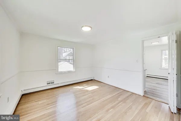 a kitchen with white cabinets white appliances and sink