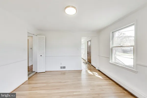 a kitchen with stainless steel appliances a white table and chairs in it