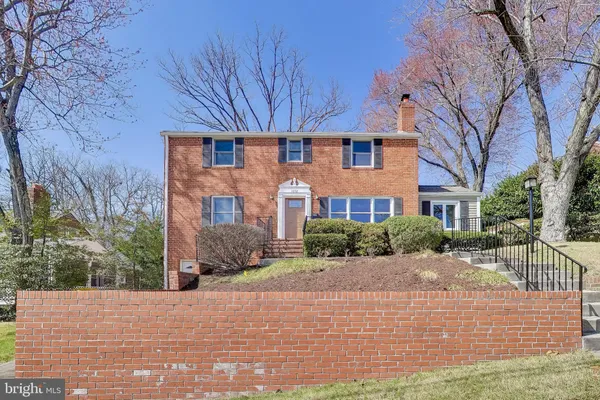 a front view of a brick house with a yard