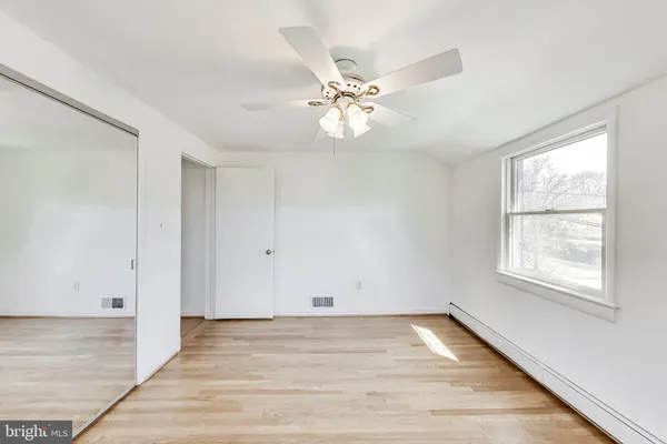 an empty room with closet area
