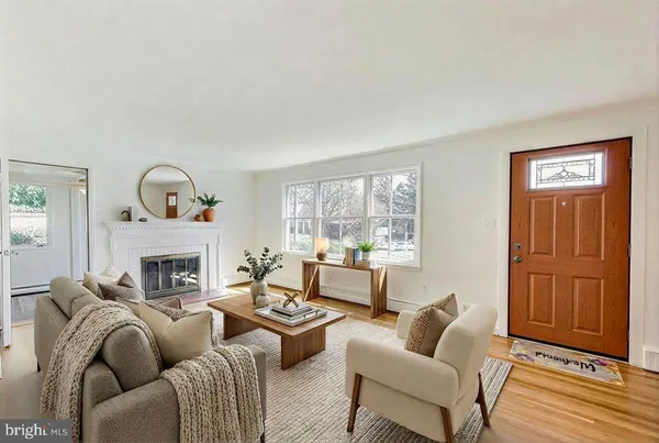 a living room with furniture a table and a fireplace