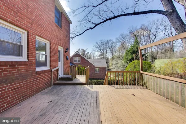 a backyard of a house with lots of green space and wooden fence