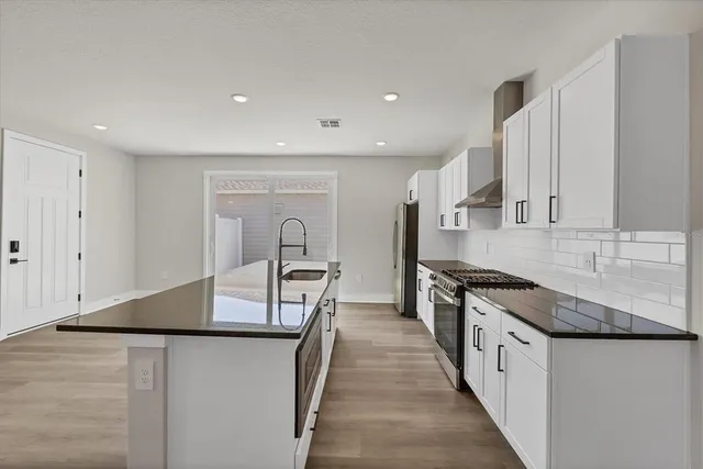 a view of a room with a ceiling fan and window