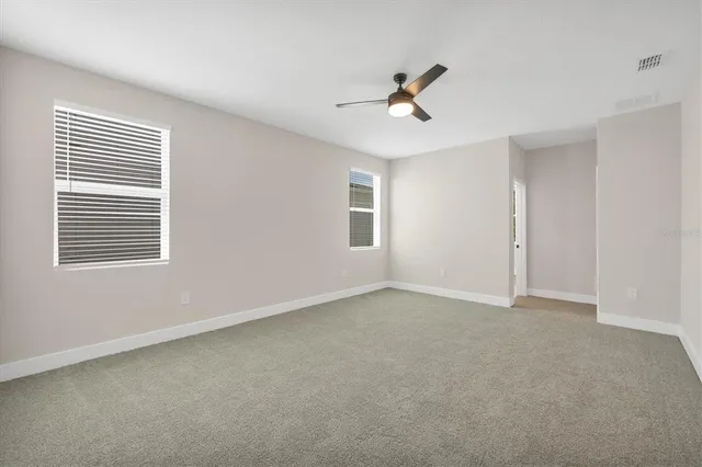an empty room with a empty space and a ceiling fan