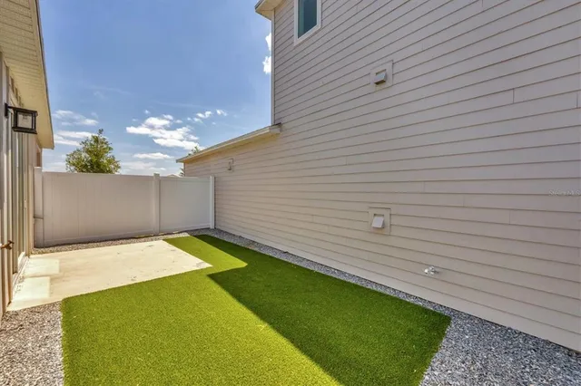 a sign board with buildings in the background