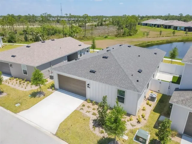 a view of a building with a yard and sitting area