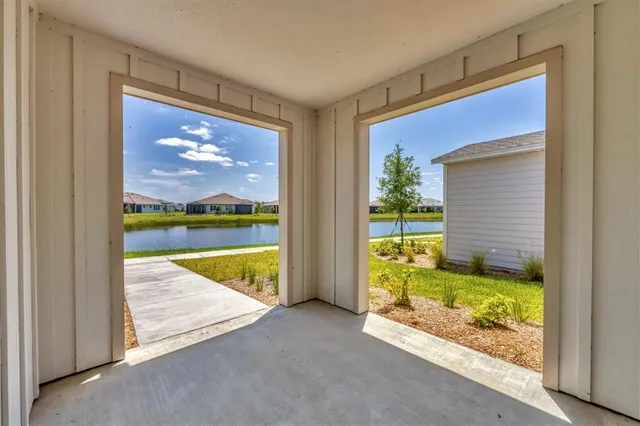 a view of empty room with wooden floor and windows