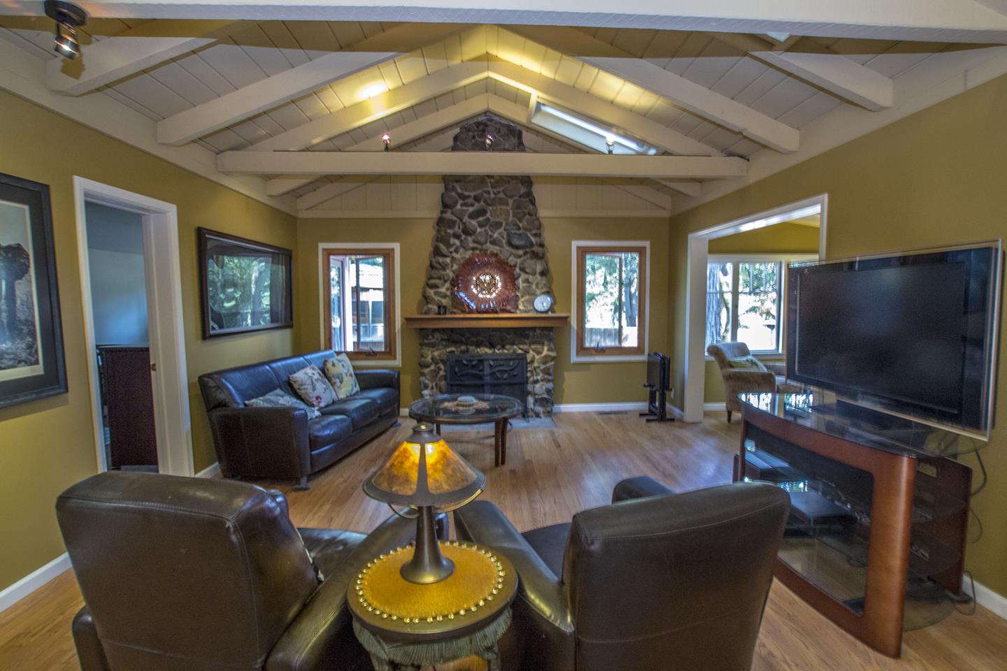 215 Chapman Road Woodside, CA 94062 - Photo 3 of 22 a living room with fireplace furniture and a flat screen tv
