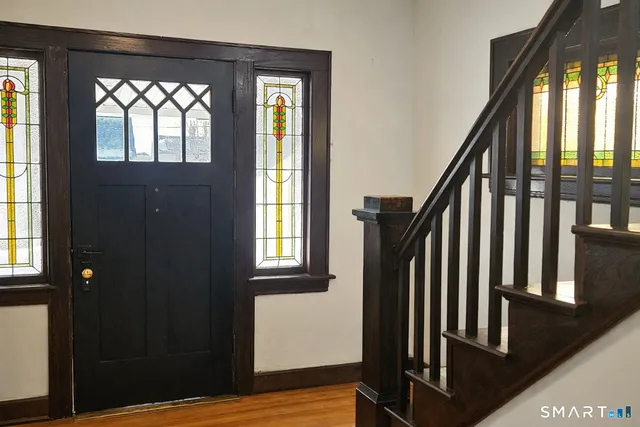 a view of an entryway with wooden floor and stairs