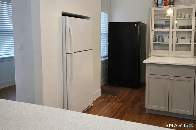 a view of a kitchen with refrigerator and cabinets