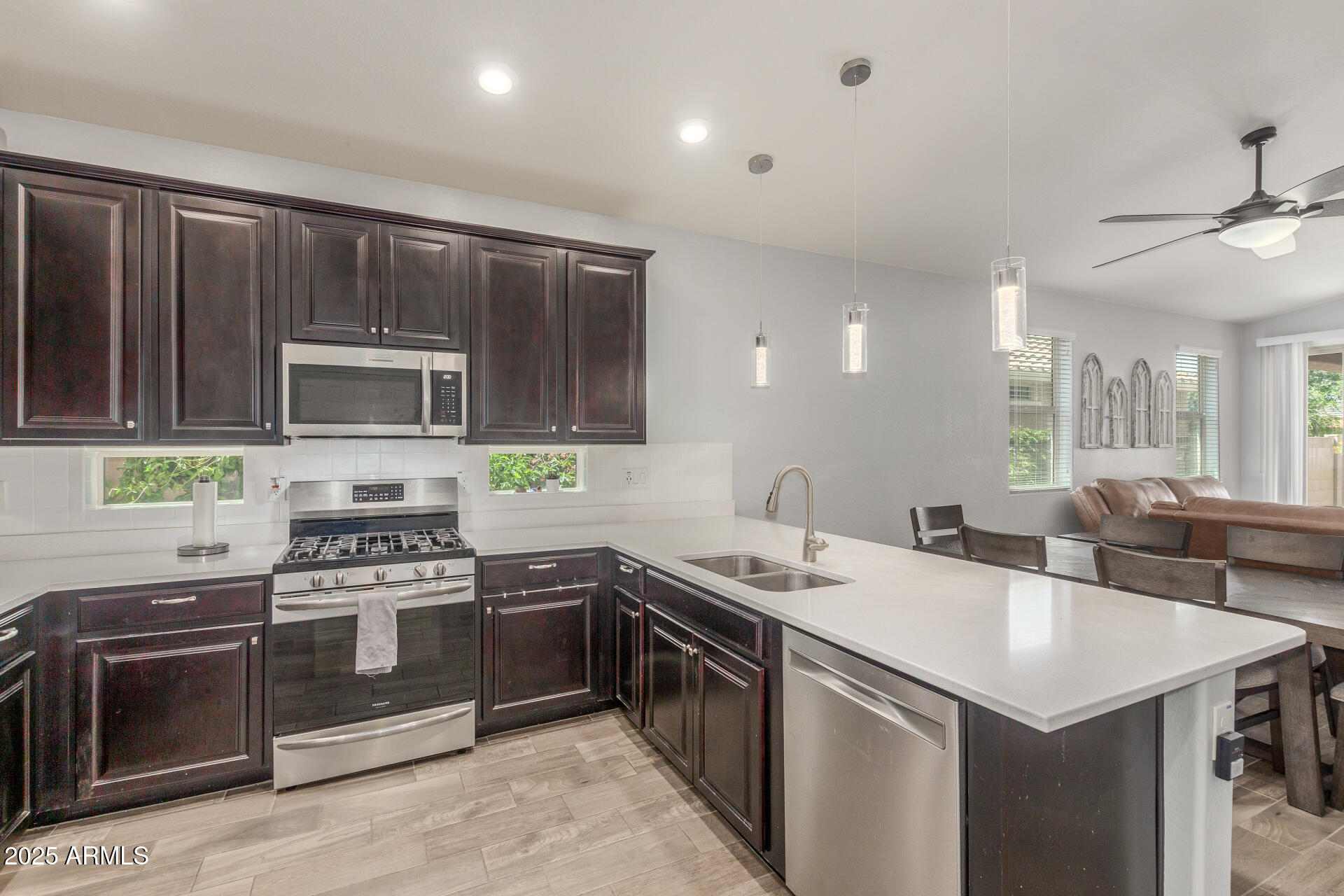 a kitchen with a stove sink and microwave